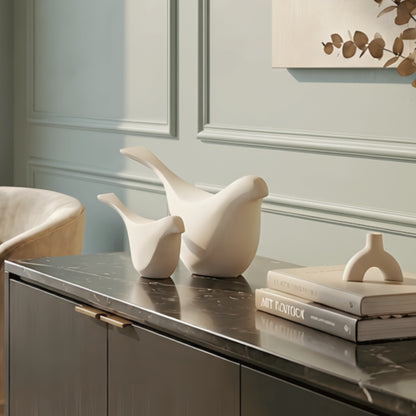 Flock white bird showpieces styled on a sideboard in a modern interior