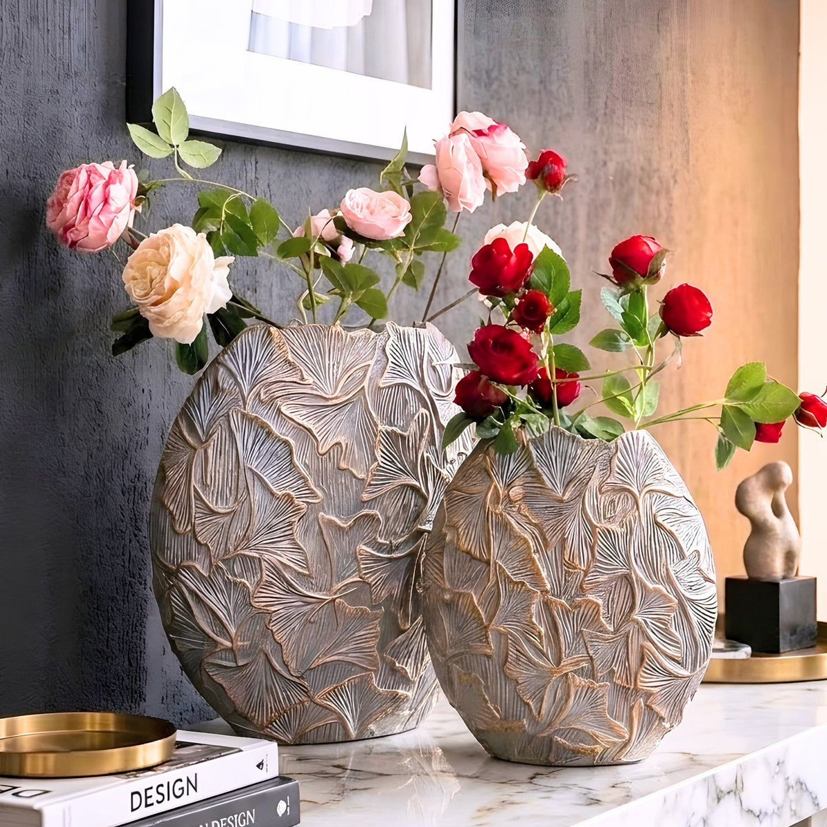 Folia grey and gold ginkgo leaf resin vases styled with flowers on a marble console