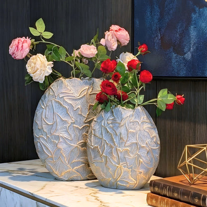 Folia sculptural grey and gold ginkgo leaf vases styled on a dark sideboard
