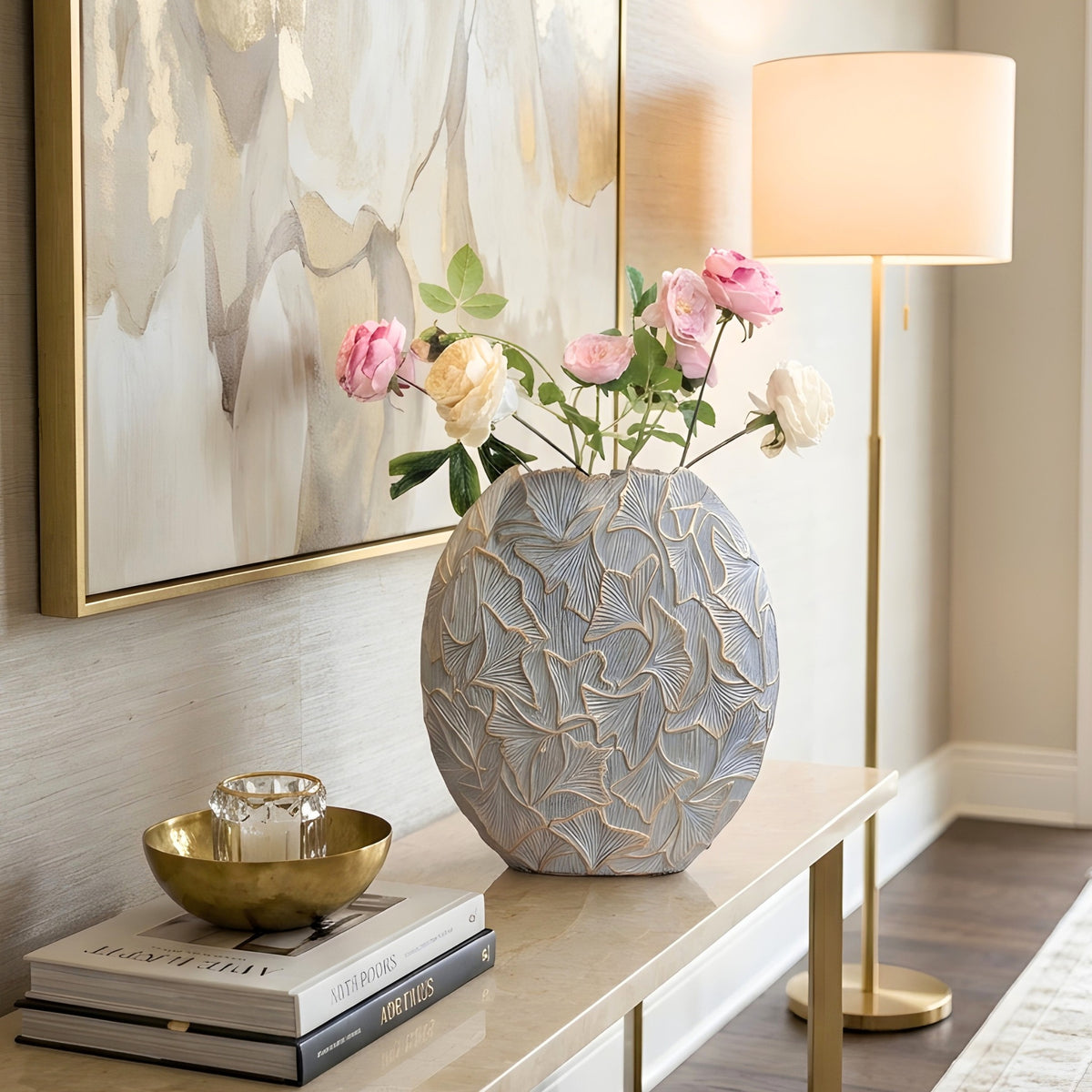 Folia large grey and gold ginkgo leaf resin vase styled on a console table