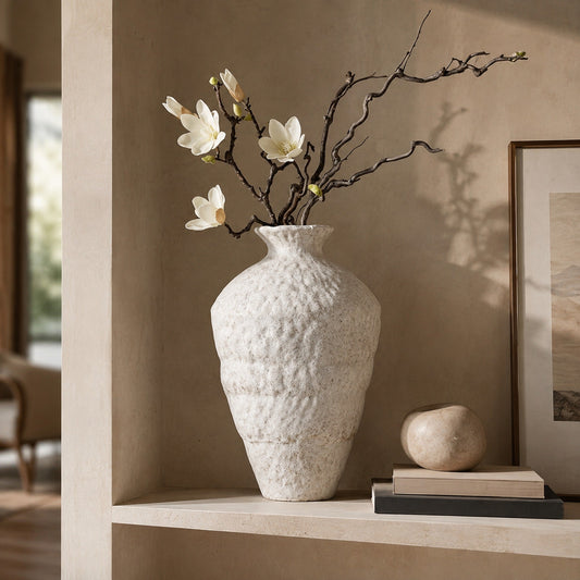 Frost textured ceramic table vase styled with magnolia branches on a neutral display shelf