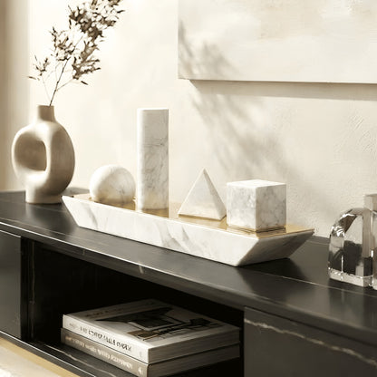 Geometry marble sphere cylinder pyramid and cube sculpture on a black console