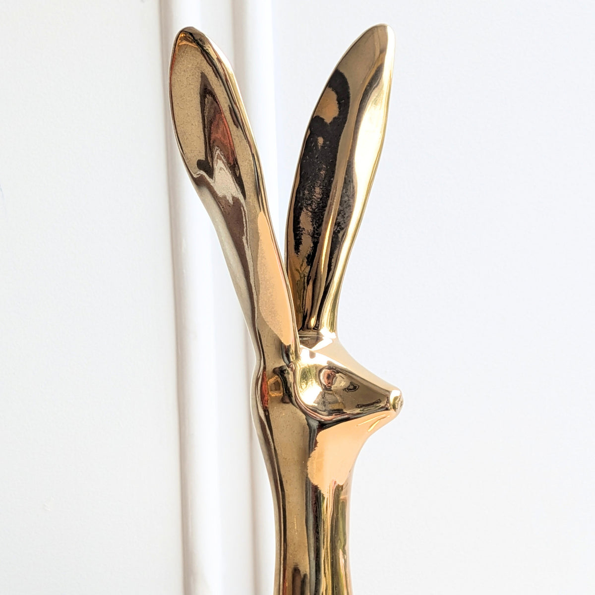 Large gold glazed ceramic rabbit showpiece with contemporary elongated silhouette