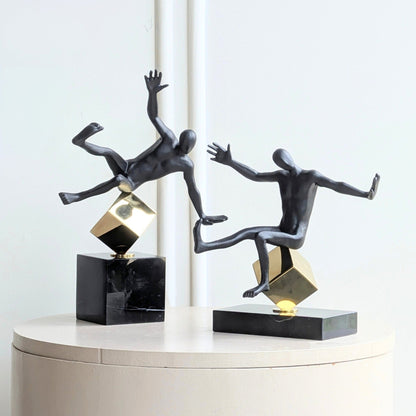 Kinesis leaning and reaching metal human showpieces displayed as a pair
