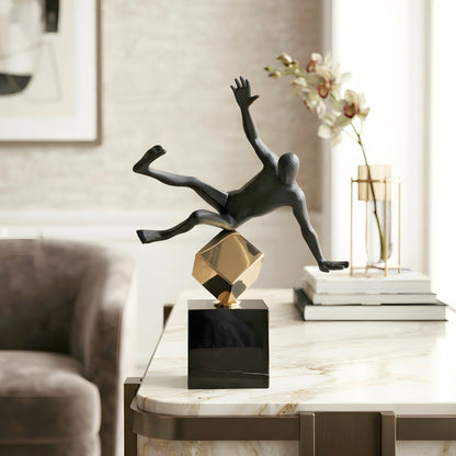 Kinesis leaning black metal human figurine styled on a marble side table