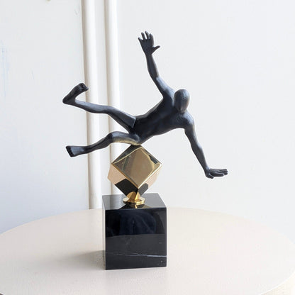Front view of the Kinesis leaning human showpiece in black and gold metal