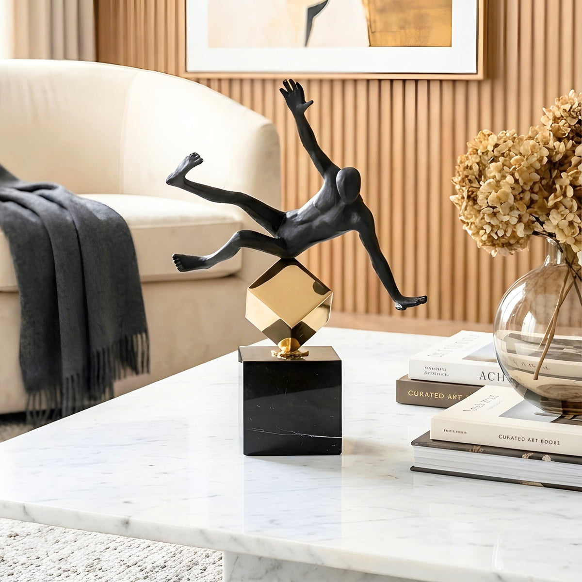 Kinesis leaning metal human figurine styled on a contemporary coffee table