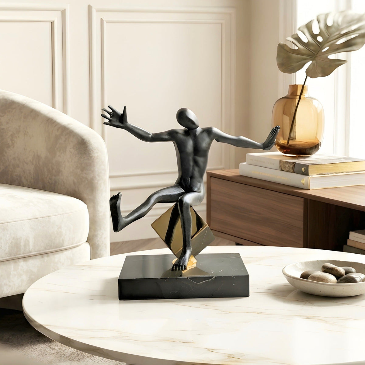 Kinesis reaching black metal human figurine styled on a coffee table