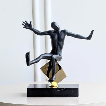 Front view of the Kinesis reaching human showpiece in black and gold metal