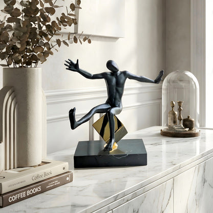 Kinesis reaching metal human figurine styled on a marble console table