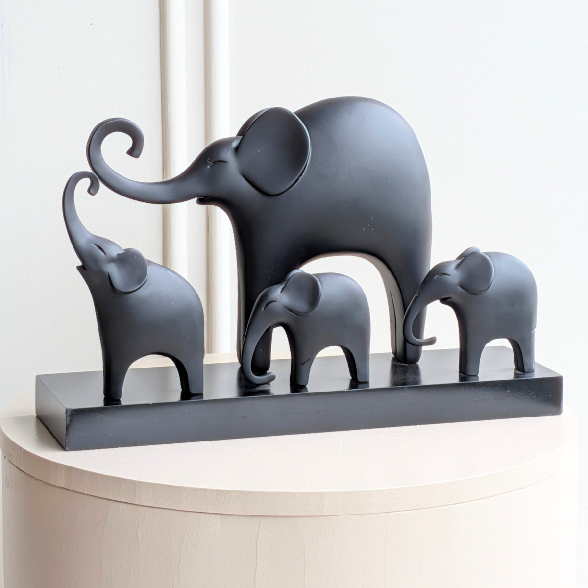 Kinship black resin elephant family showpiece with four elephants on a rectangular base for luxury console styling, view 4