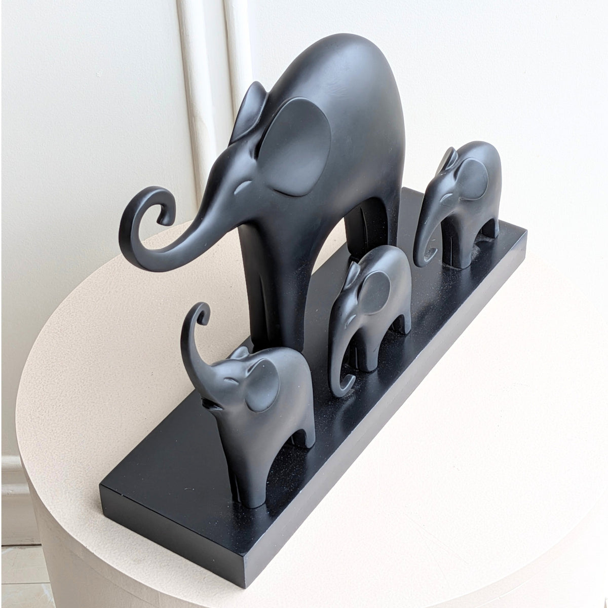 Kinship black resin elephant family showpiece with four elephants on a rectangular base for luxury console styling, view 7
