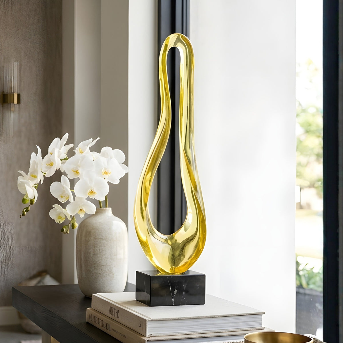 Loop gold abstract resin and marble showpiece styled on a modern console table