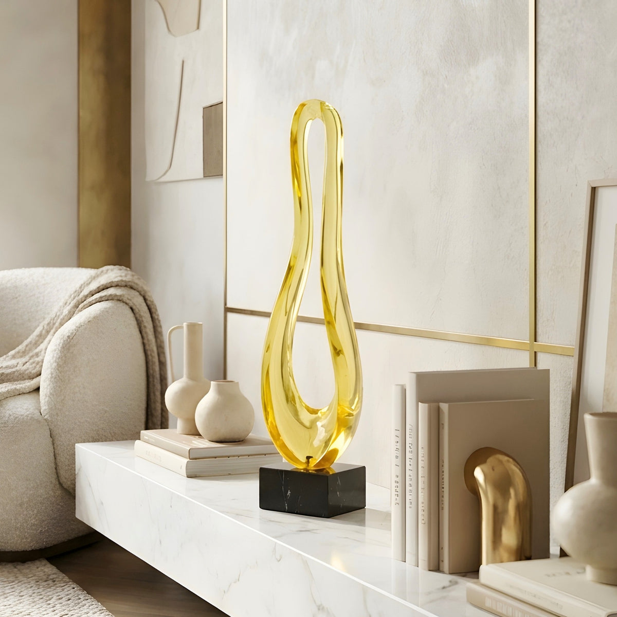 Loop modern abstract gold showpiece styled on a low marble TV unit