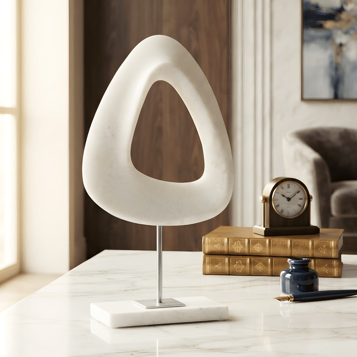 Loop marble base abstract sculpture styled in a refined home study