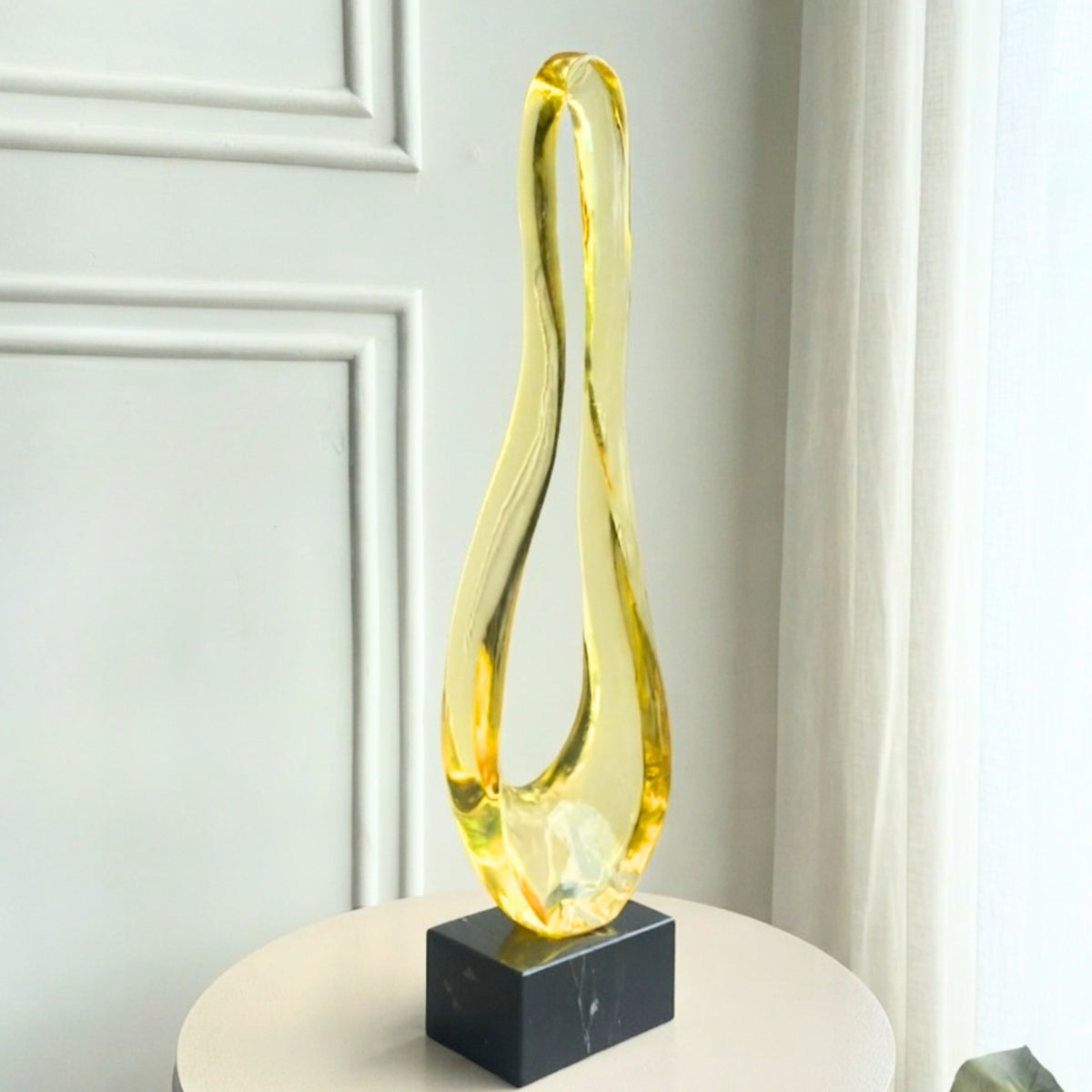 Loop modern abstract gold resin showpiece on black marble base