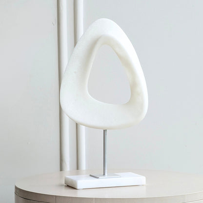 Front view of Loop sandstone resin sculpture with a white marble base