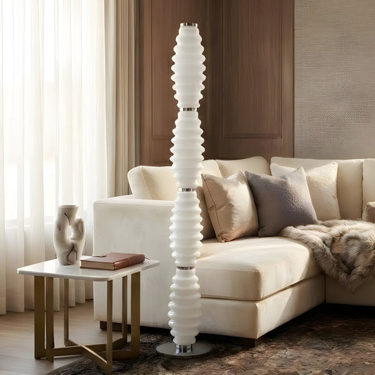 Luma Totem 5.5 ft floor lamp beside cream sofa