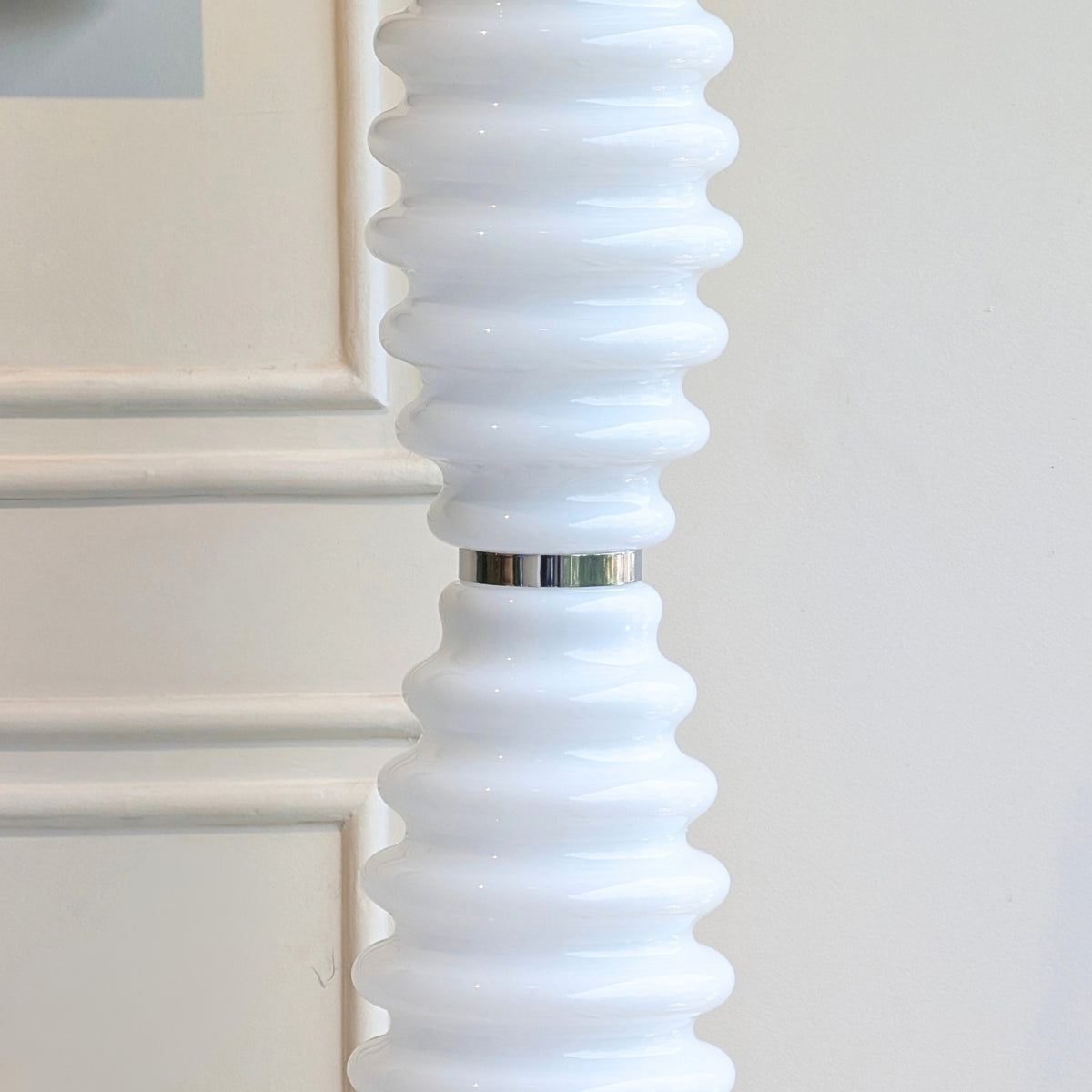Close-up of ribbed white glass and stainless steel detailing on Luma Totem floor lamp
