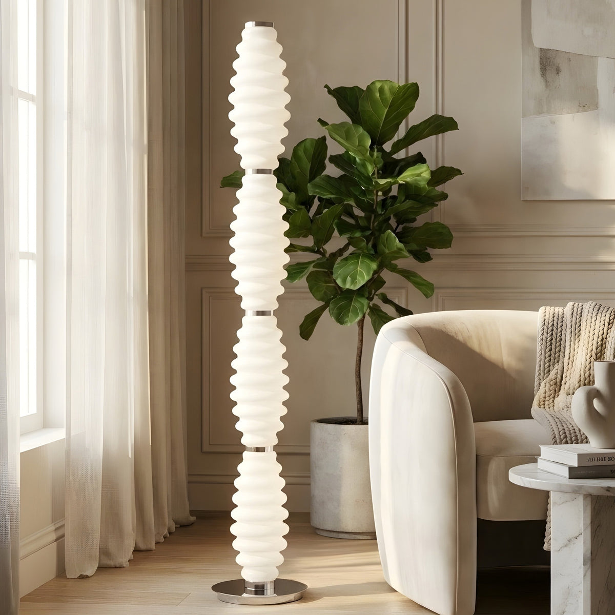 Luma Totem tall glass floor lamp beside lounge chair