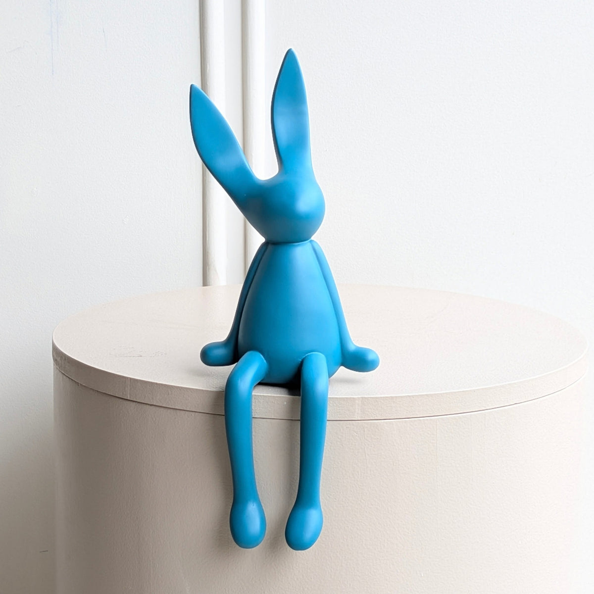 Meadow blue resin rabbit showpiece with long ears and dangling legs