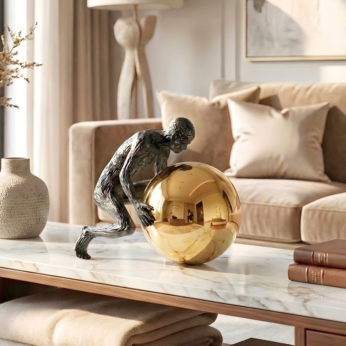 Strive black textured metal figure and reflective golden sphere shown from another angle