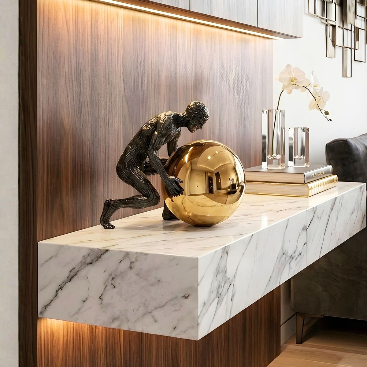 Strive black and gold metal sculpture on an illuminated marble shelf