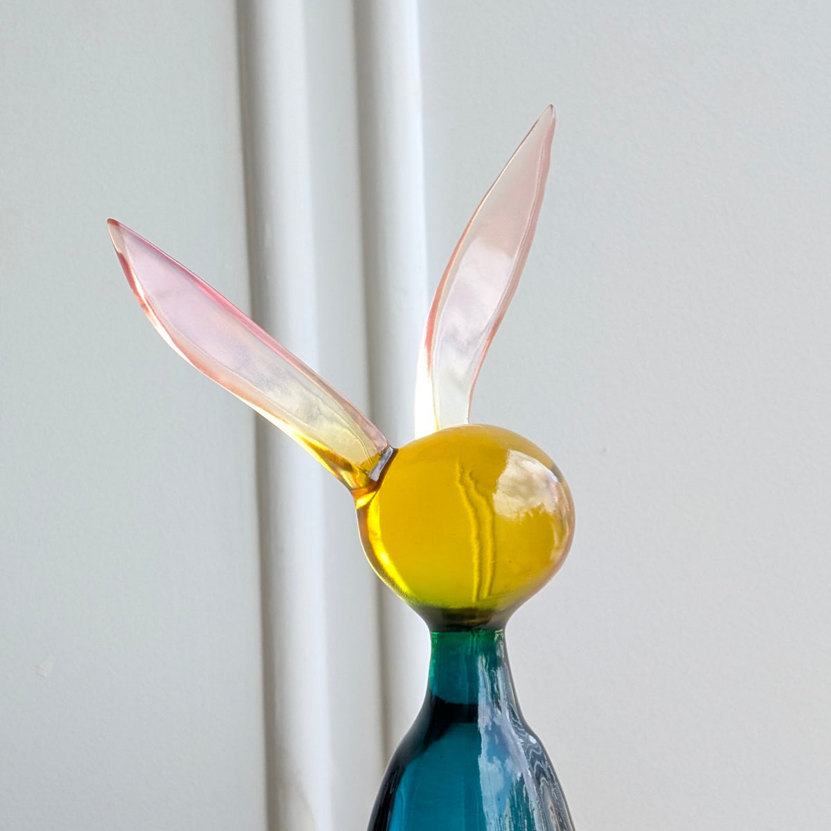 Close-up of Moxie resin bunny ears and yellow transparent rounded head