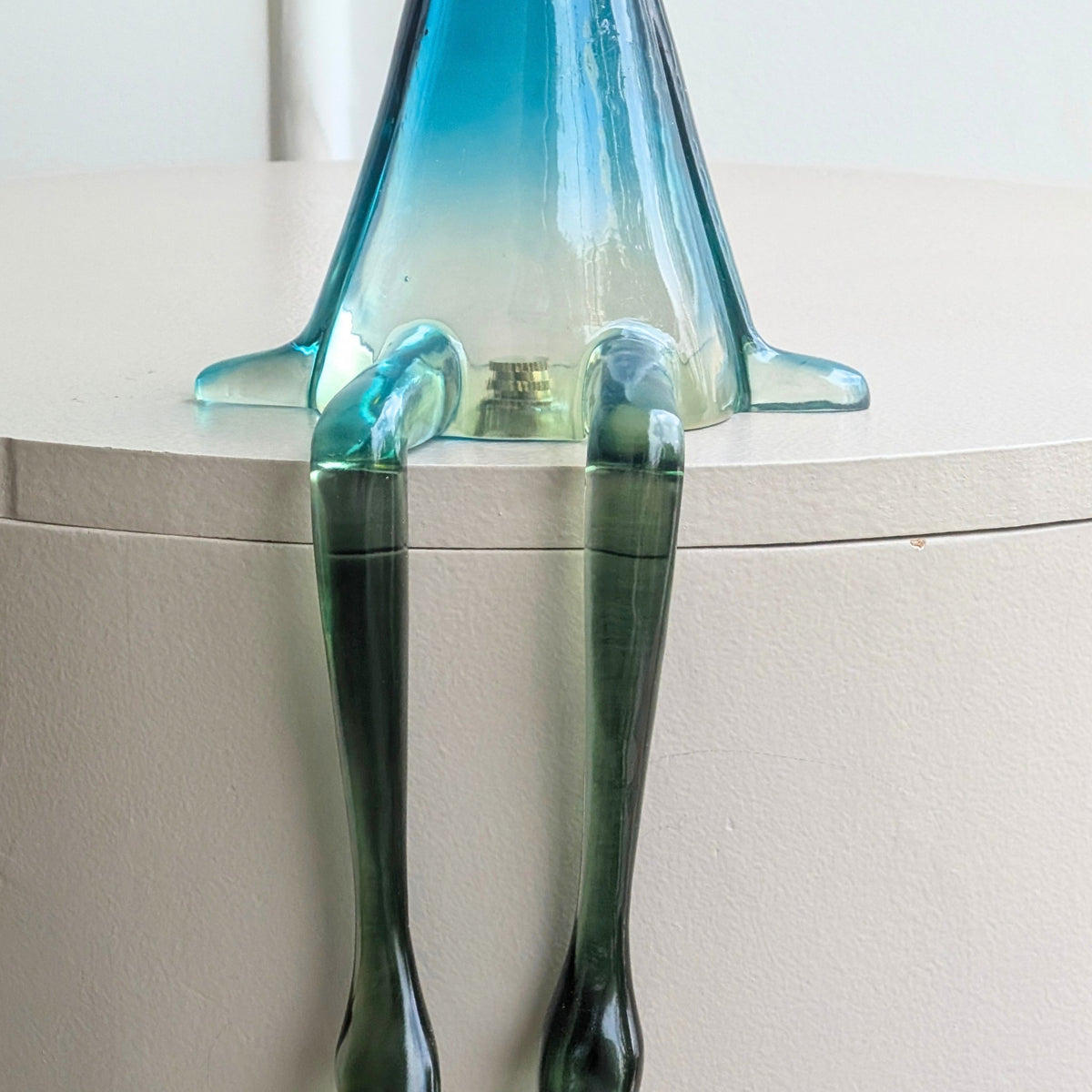 Close-up of Moxie translucent resin rabbit seated with hanging legs