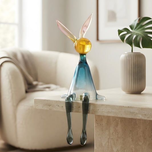 Moxie resin rabbit figurine with dangling legs styled on a modern console