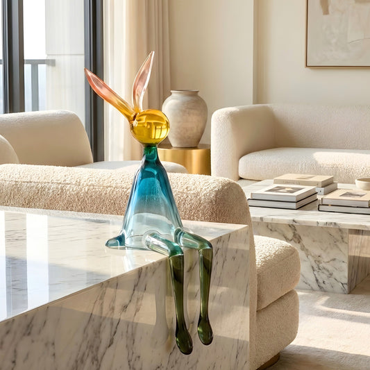 Moxie colourful rabbit showpiece styled on marble furniture in a modern living room
