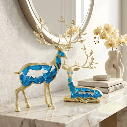 Mystique blue resin and gold metal deer showpieces styled on a marble console table