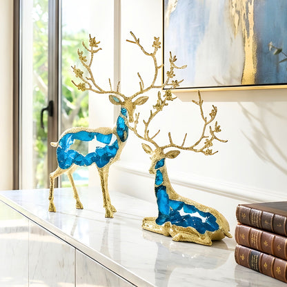 Mystique standing and sitting deer showpieces in translucent blue resin with gold-toned metal details