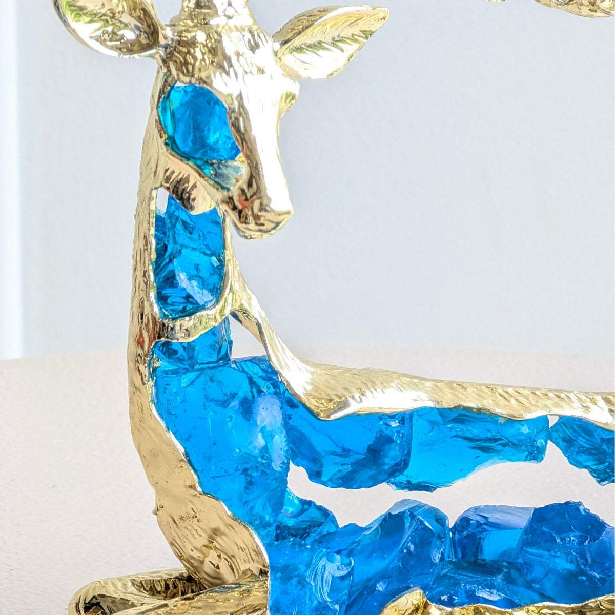Translucent blue resin body detail of the Mystique sitting deer showpiece
