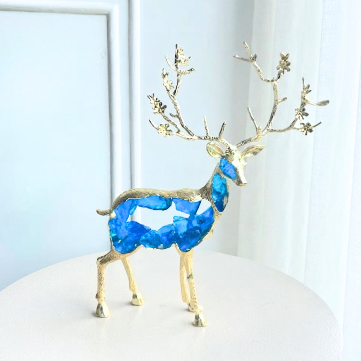 Mystique standing deer showpiece with translucent blue resin body and gold-toned antlers