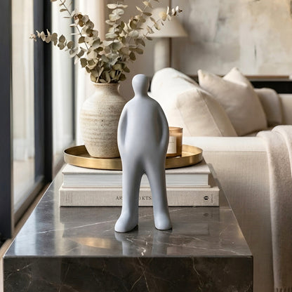 Off Duty Grey resin abstract human figurine on a marble coffee table