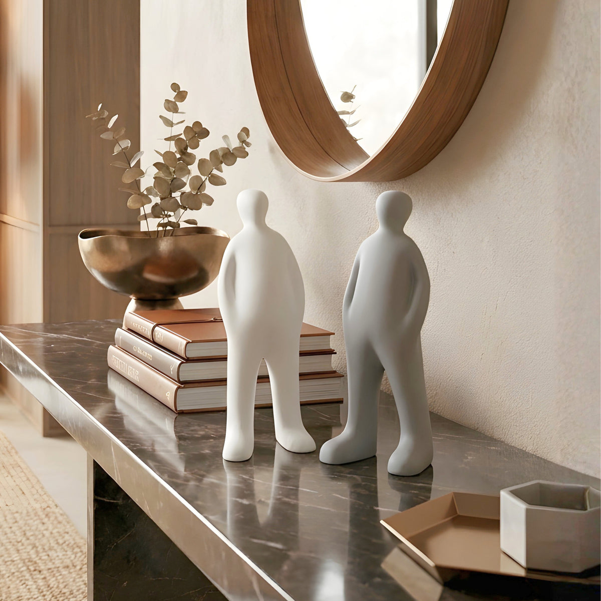 Off Duty white and grey minimalist resin human showpieces styled on a marble entryway console