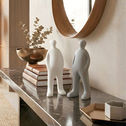 Off Duty white and grey minimalist resin human showpieces styled on a marble entryway console