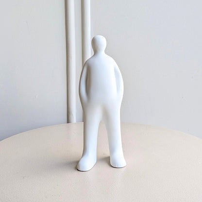 Off Duty White minimalist resin human figurine styled beside books