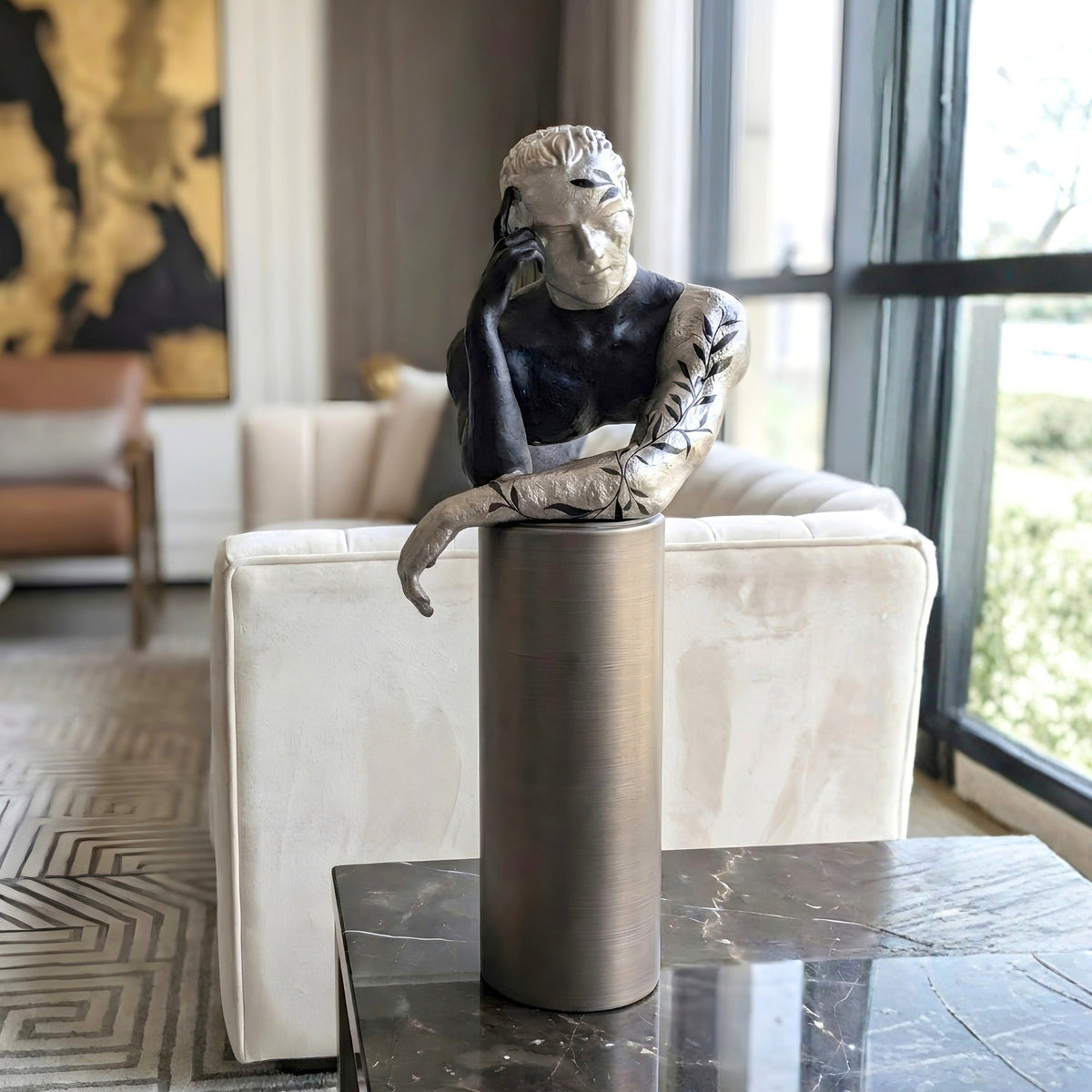Pensive contemplative human figurine styled on a modern living room coffee table