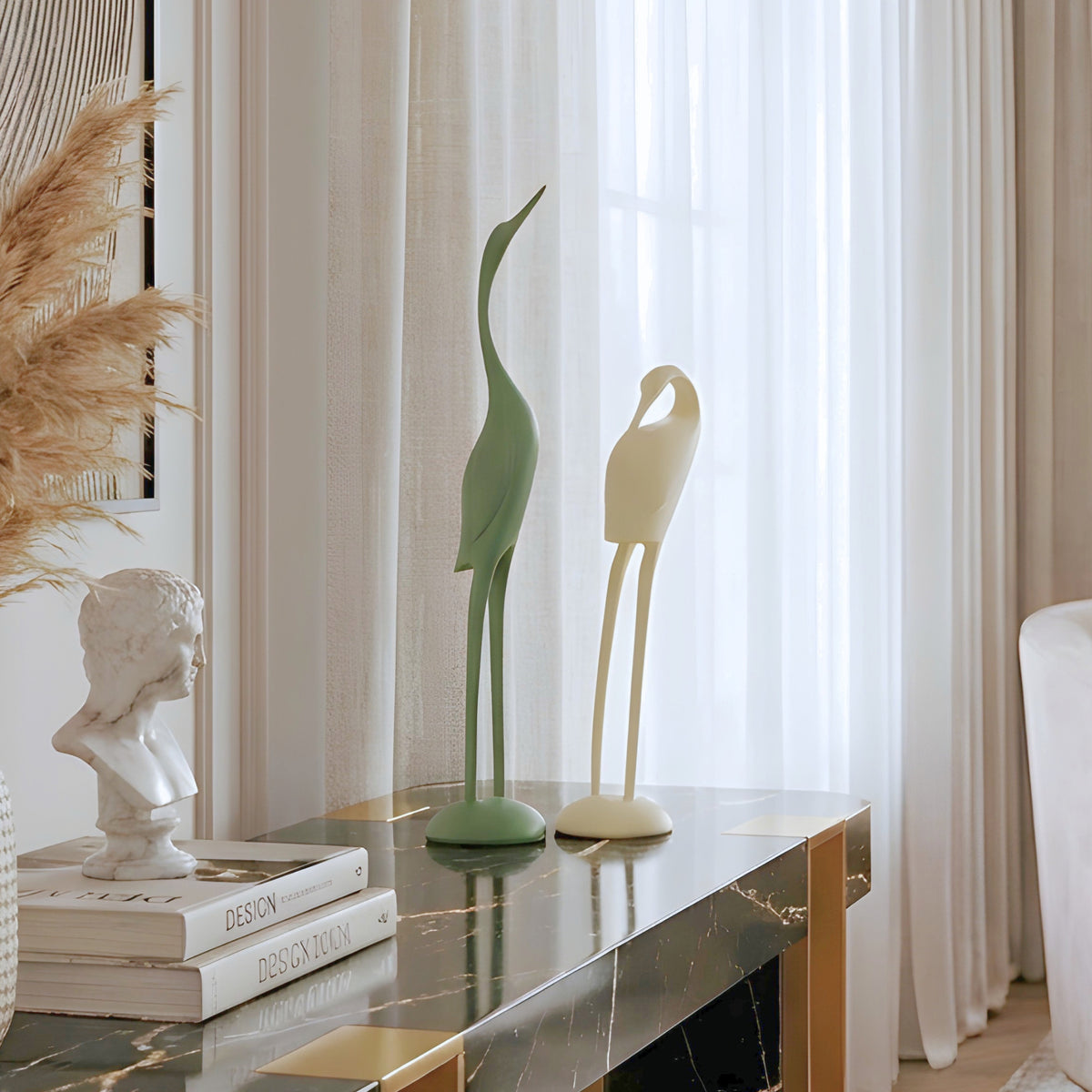 Poise green and ivory bird sculpture set styled on a dark marble entryway console