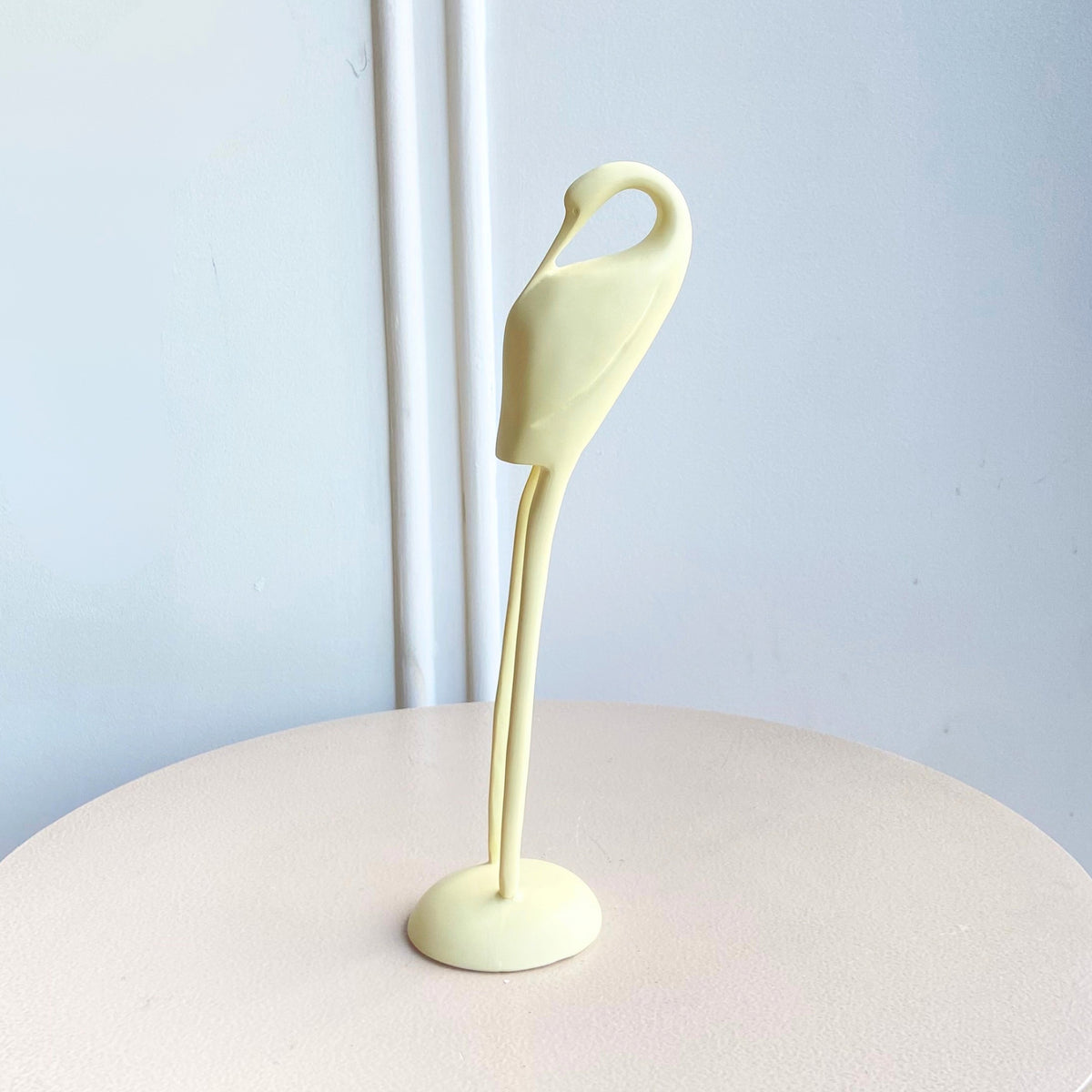 Ivory resin bird figurine with a curved neck and slender legs in the Poise showpiece set