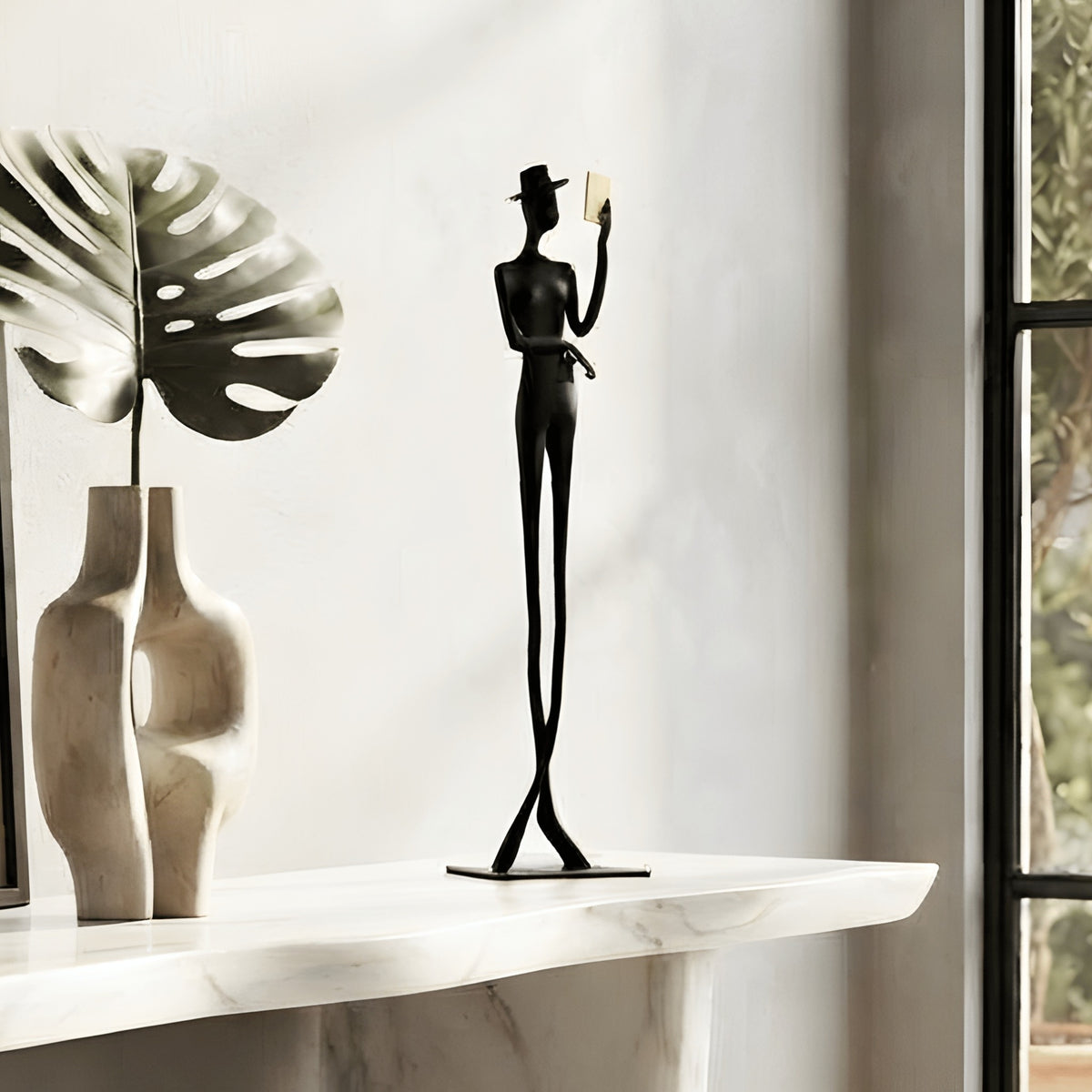 Poise black metal gentleman figurine styled on an entryway console