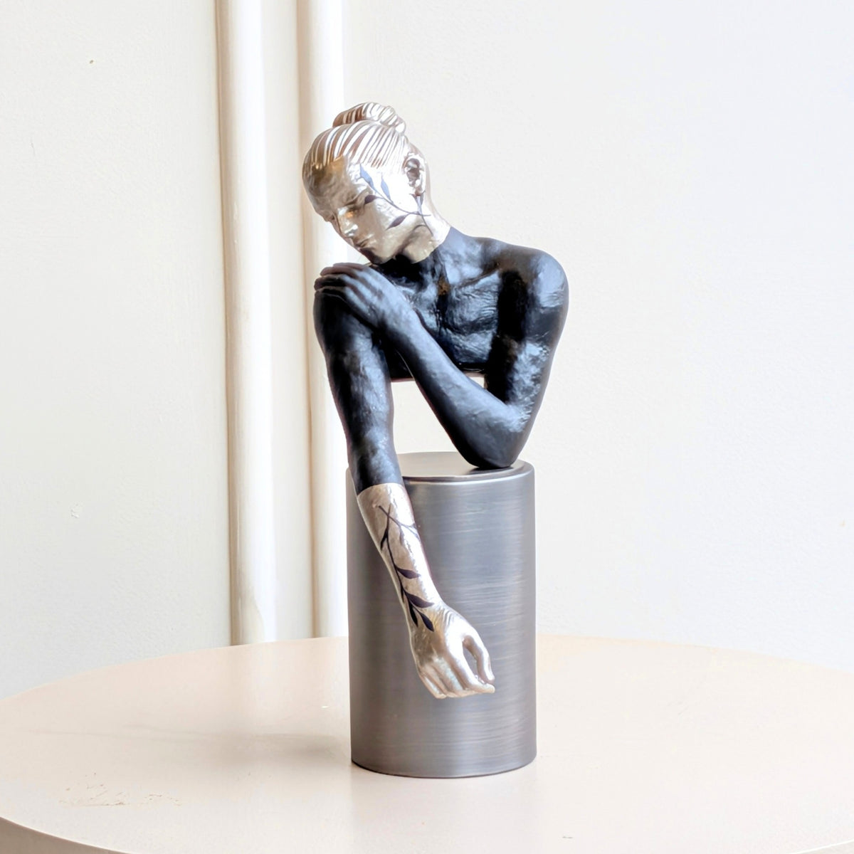 Poise metal and resin resting woman figurine with silver pedestal