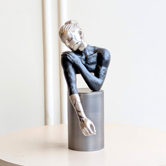 Poise metal and resin resting woman figurine with silver pedestal