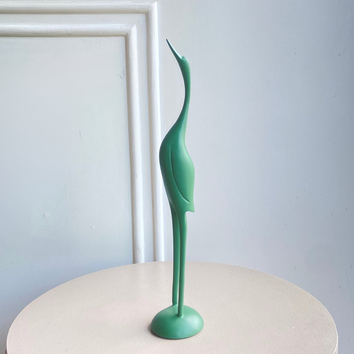 Mint green Poise resin bird figurine with an elongated neck and rounded base