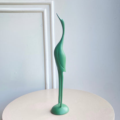 Mint green Poise resin bird figurine with an elongated neck and rounded base