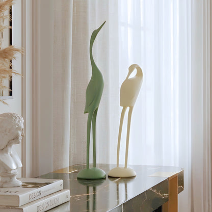 Poise pair of green and ivory resin bird sculptures styled on a luxury living room console table