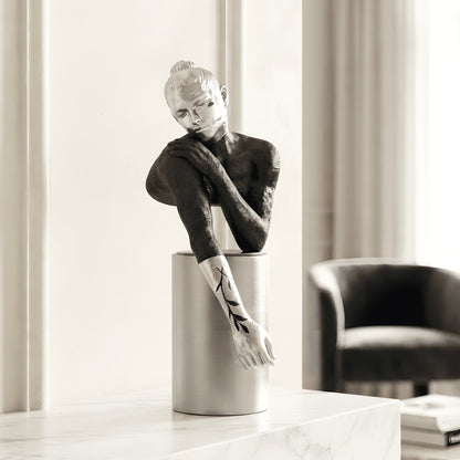 Poise black and silver resting woman figurine styled on a living room console