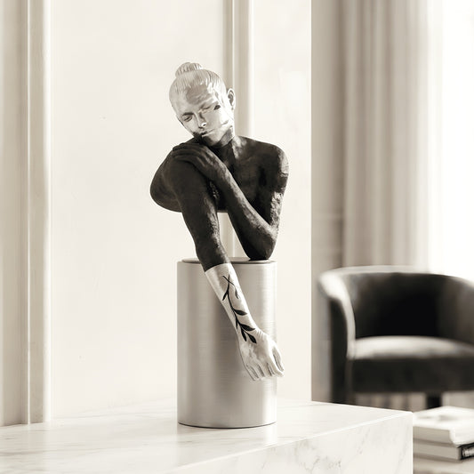 Poise black and silver resting woman figurine styled on a living room console